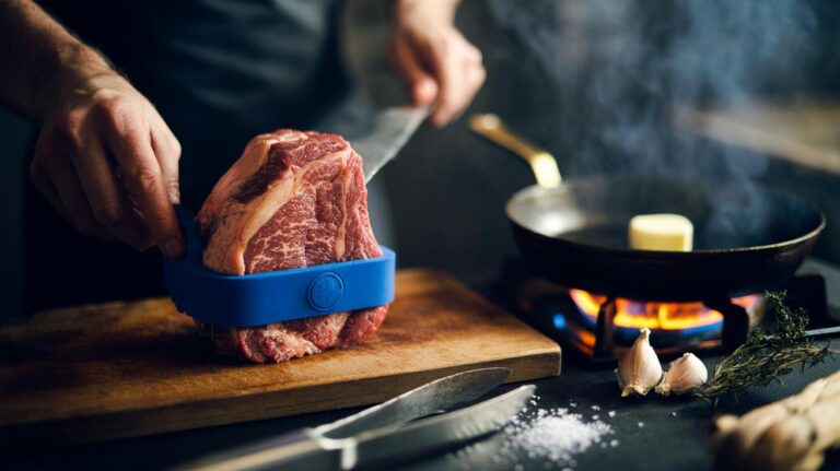 Illustration of a cook using a food-safe silicone band to shape a steak to even thickness before a three-minute pan sear